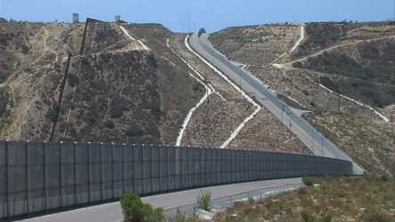 A wide angle view of a stretch of border fence